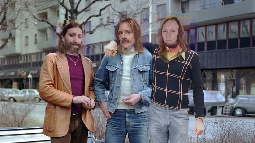 Tre personer står tillsammans utomhus framför ett bostadshus. De har vardagskläder, bland annat utsvängda byxor i sjuttiotalsstil. Bilden är ett fotomontage där alla har inklippta skägg eller mustascher.